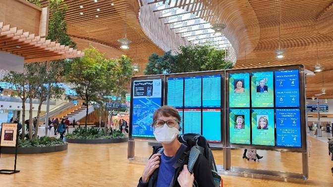 A person wearing a mask in a airport

Description automatically generated