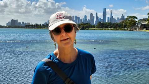 A person in a hat and sunglasses standing in front of a body of water

AI-generated content may be incorrect.