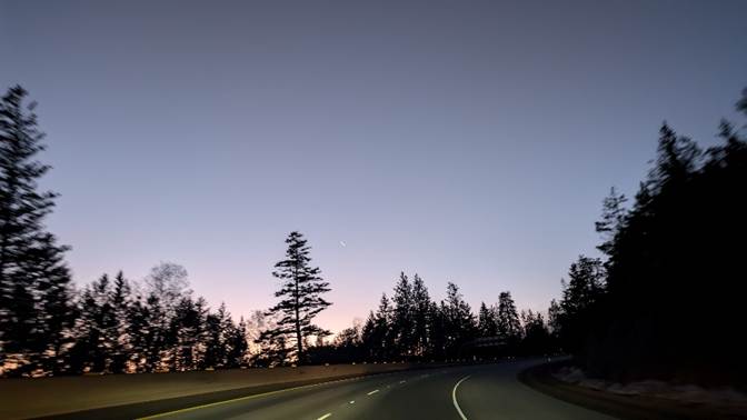 A road with trees in the background

Description automatically generated