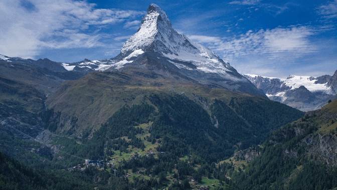 A mountain with snow on top

Description automatically generated