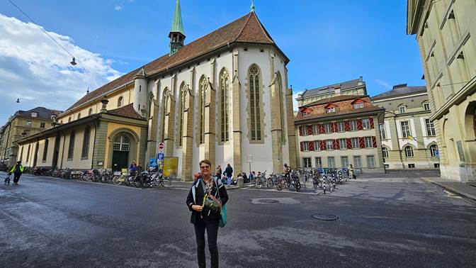 A person standing in front of a building

Description automatically generated