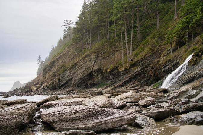 A waterfall on a rocky beach